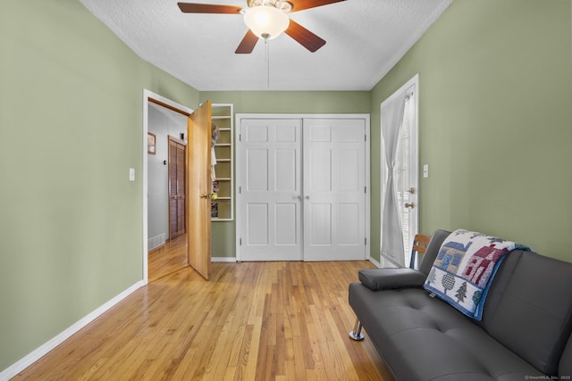 98 Cynthia Dr, West Haven, CT 06516 - living area with light wood finished floors, a ceiling fan, a textured ceiling, and baseboards