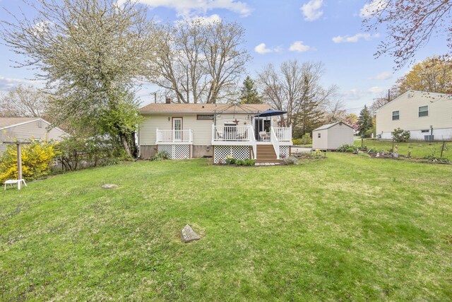 98 Cynthia Dr, West Haven, CT 06516 - rear view of property featuring a deck, an outbuilding, a storage shed, a lawn, and fence
