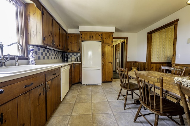 16 November Trl, Haddam, CT 06438 - kitchen featuring tasteful backsplash, white appliances, light countertops, a wainscoted wall, and a sink
