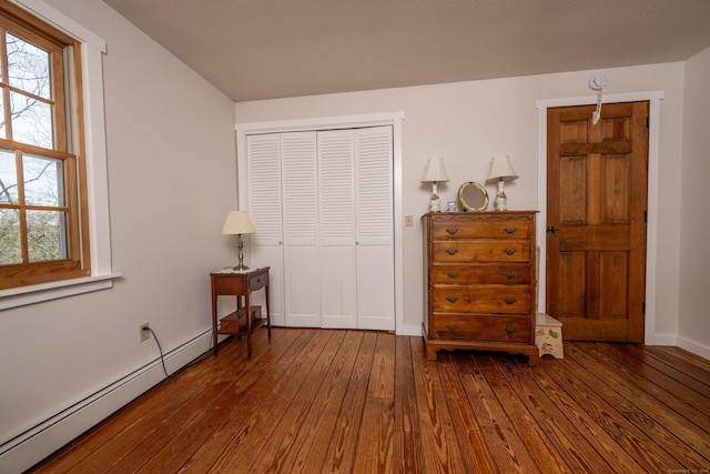 16 November Trl, Haddam, CT 06438 - bedroom with baseboards, dark wood-style flooring, a closet, and a baseboard radiator