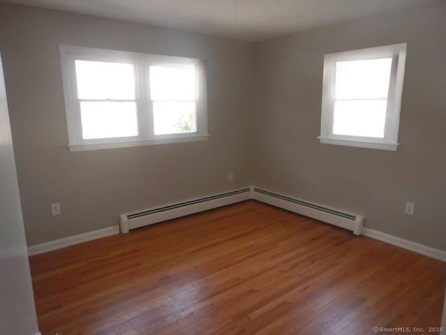 48 W Vine St, Stonington, CT 06379 - empty room featuring baseboard heating, baseboards, and wood finished floors