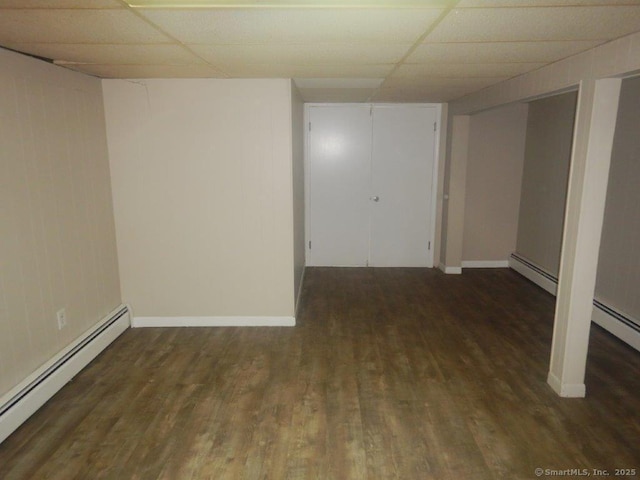 48 W Vine St, Stonington, CT 06379 - finished below grade area featuring a paneled ceiling, wood finished floors, and a baseboard radiator