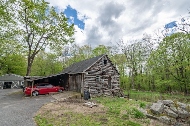 469 Platt Hill Rd, Winchester, CT 06098 - view of outbuilding featuring a carport, driveway, and an outdoor structure