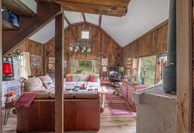 469 Platt Hill Rd, Winchester, CT 06098 - living area featuring a wood stove, wood finished floors, wooden walls, and plenty of natural light