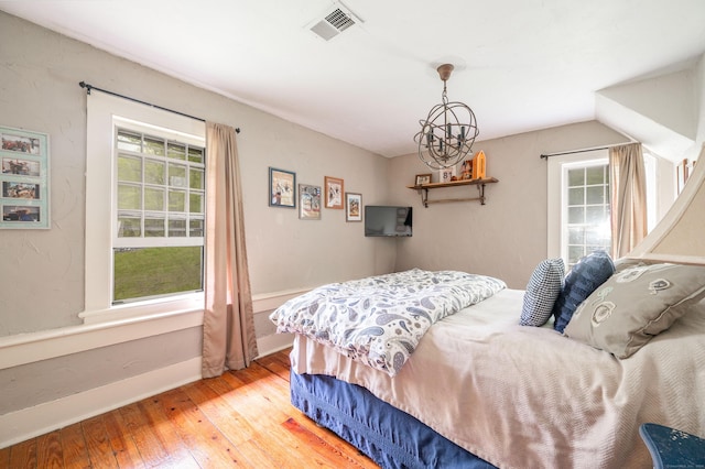 469 Platt Hill Rd, Winchester, CT 06098 - bedroom with wood-type flooring, baseboards, an inviting chandelier, and multiple windows