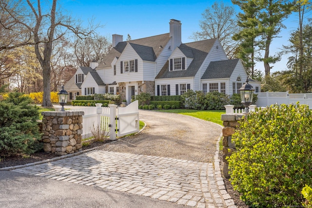 9 High Ridge Rd, Wilton, CT 06897 - exterior space featuring a gate, decorative driveway, a fenced front yard, a chimney, and stone siding