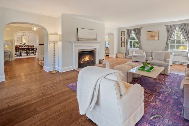 9 High Ridge Rd, Wilton, CT 06897 - living area with arched walkways, radiator heating unit, hardwood / wood-style flooring, and ornamental molding