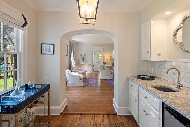 9 High Ridge Rd, Wilton, CT 06897 - hallway featuring arched walkways, a wealth of natural light, dark wood-type flooring, and a sink
