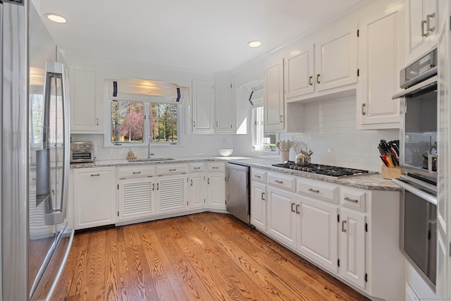 9 High Ridge Rd, Wilton, CT 06897 - kitchen with white cabinets, a sink, light wood-type flooring, backsplash, and appliances with stainless steel finishes