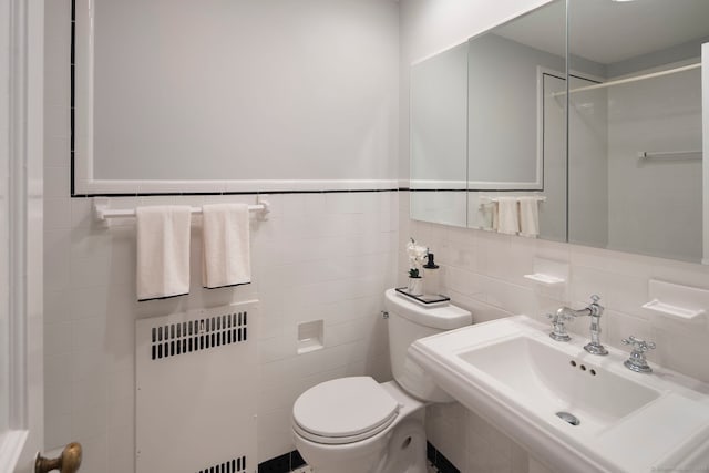9 High Ridge Rd, Wilton, CT 06897 - bathroom featuring radiator, toilet, a sink, and tile walls