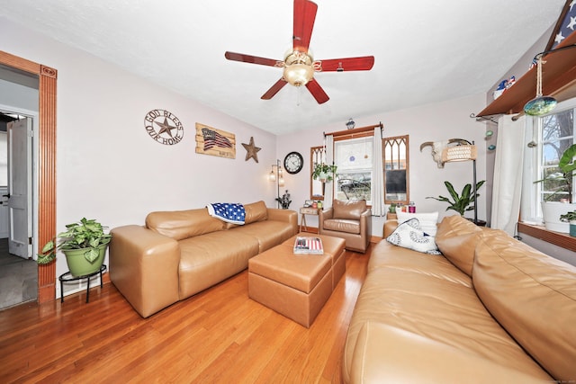 living area featuring wood finished floors and a ceiling fan