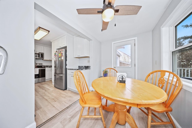 dining room with light wood-style flooring and ceiling fan
