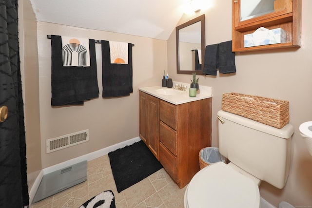 bathroom featuring tile patterned floors, vaulted ceiling, visible vents, toilet, and vanity