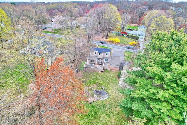bird's eye view with a wooded view