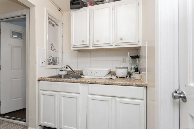 bar with a sink and tasteful backsplash