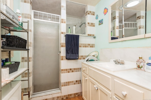 full bath featuring a shower stall, vanity, and wood finished floors