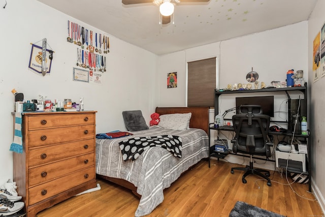 bedroom with a ceiling fan and wood finished floors