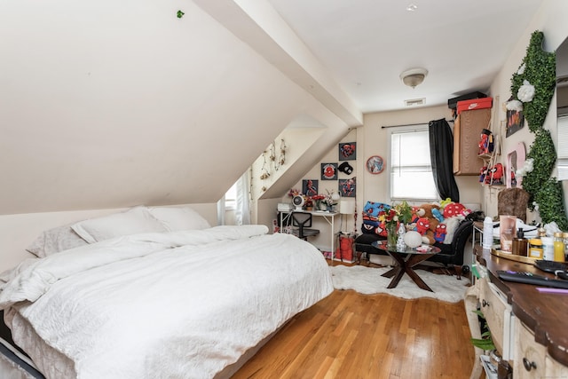 bedroom featuring light wood-type flooring and visible vents