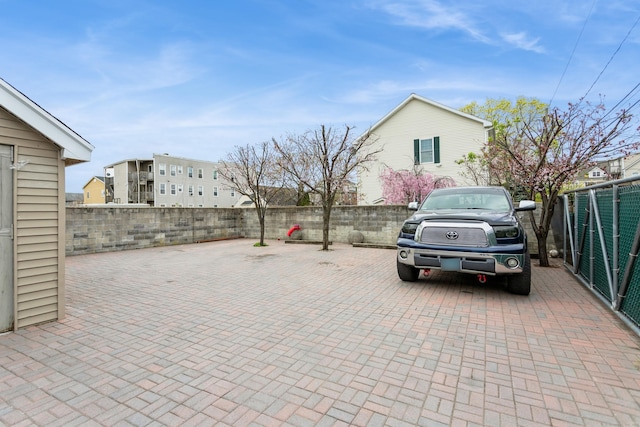 view of car parking with a fenced backyard