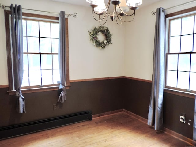 190 Wickham Rd, East Haddam, CT 06423 - empty room with a baseboard heating unit, a chandelier, wood finished floors, and baseboards
