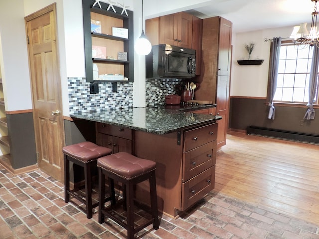 190 Wickham Rd, East Haddam, CT 06423 - kitchen with black microwave, baseboard heating, a kitchen breakfast bar, pendant lighting, and backsplash