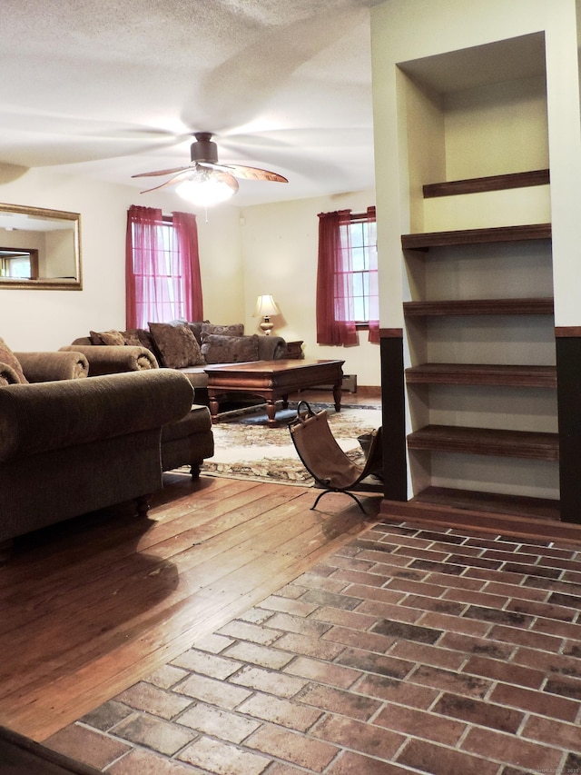 190 Wickham Rd, East Haddam, CT 06423 - living room featuring healthy amount of natural light, ceiling fan, and brick flooring