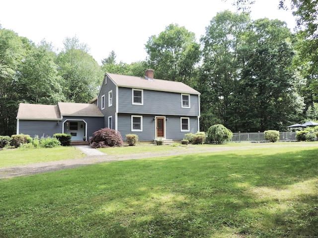 190 Wickham Rd, East Haddam, CT 06423 - colonial-style house with a chimney, view of wooded area, and a shingled roof