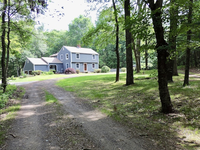 190 Wickham Rd, East Haddam, CT 06423 - view of front of house featuring a chimney, driveway, a front lawn, a gambrel roof, and a view of trees