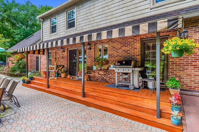 wooden terrace featuring grilling area and a patio area