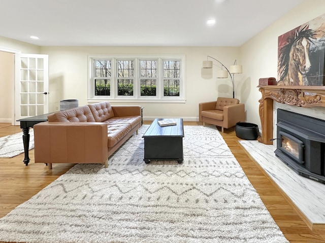 living room with recessed lighting, baseboards, and wood finished floors