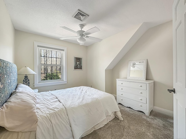 carpeted bedroom with visible vents, a textured ceiling, ceiling fan, and baseboards