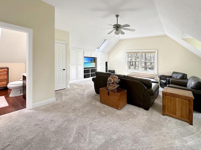 living room with ceiling fan, lofted ceiling, and light carpet