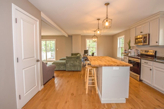 3 Henry Rd, Enfield, CT 06082 - kitchen featuring wood counters, light wood finished floors, a healthy amount of sunlight, and stainless steel appliances