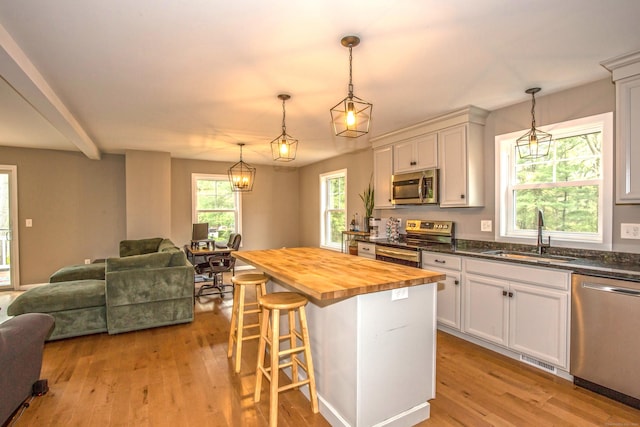 3 Henry Rd, Enfield, CT 06082 - kitchen with appliances with stainless steel finishes, a sink, open floor plan, light wood-style floors, and butcher block countertops