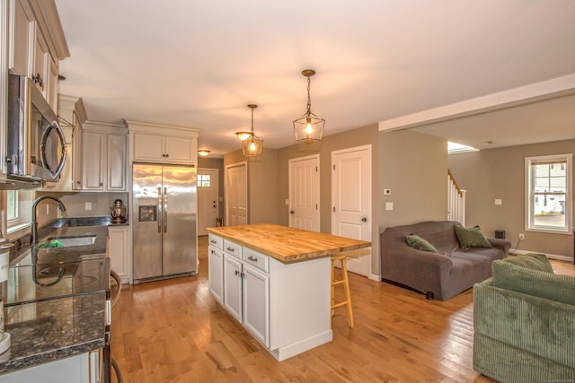 3 Henry Rd, Enfield, CT 06082 - kitchen featuring wooden counters, light wood-type flooring, open floor plan, a breakfast bar, and stainless steel appliances