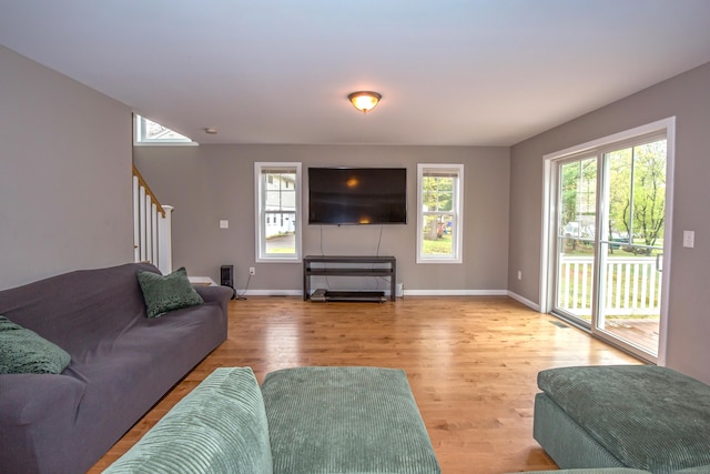 3 Henry Rd, Enfield, CT 06082 - living area with a healthy amount of sunlight, stairway, and wood finished floors