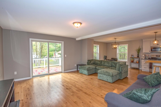 3 Henry Rd, Enfield, CT 06082 - living room with light wood-style floors, baseboards, and a chandelier