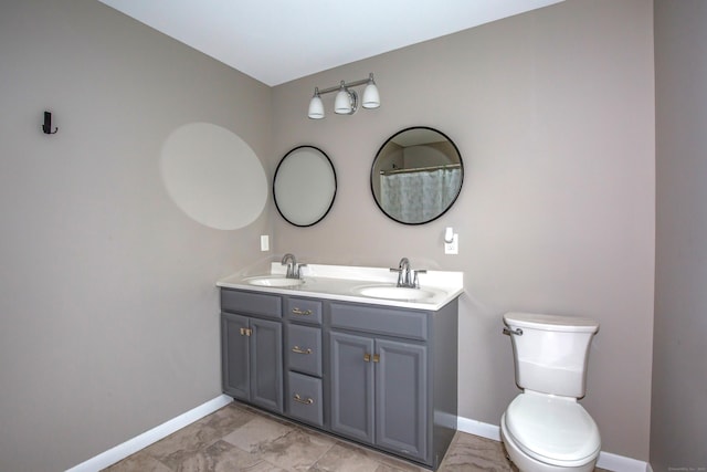3 Henry Rd, Enfield, CT 06082 - full bathroom featuring baseboards, a sink, double vanity, and toilet