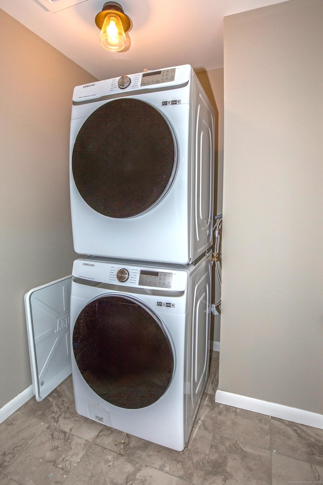 3 Henry Rd, Enfield, CT 06082 - laundry area with baseboards, stacked washer and clothes dryer, and laundry area