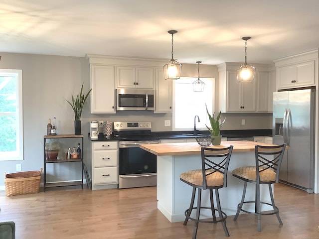 3 Henry Rd, Enfield, CT 06082 - kitchen featuring stainless steel appliances, plenty of natural light, butcher block countertops, and a kitchen island