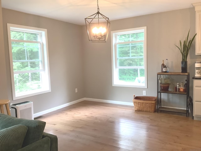 3 Henry Rd, Enfield, CT 06082 - sitting room with light wood finished floors, a chandelier, and baseboards