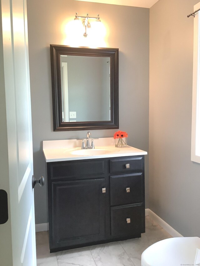 3 Henry Rd, Enfield, CT 06082 - bathroom with marble look tile flooring, vanity, baseboards, and toilet