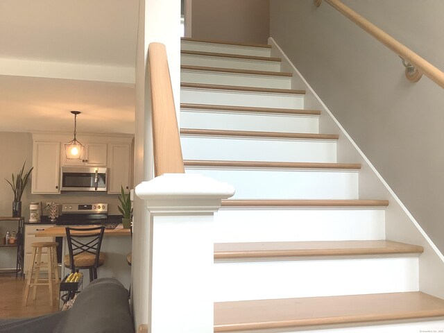 3 Henry Rd, Enfield, CT 06082 - stairway featuring wood finished floors