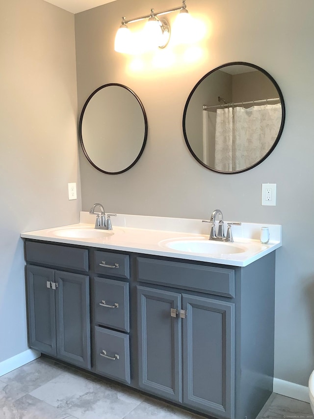 3 Henry Rd, Enfield, CT 06082 - bathroom with double vanity, baseboards, and toilet