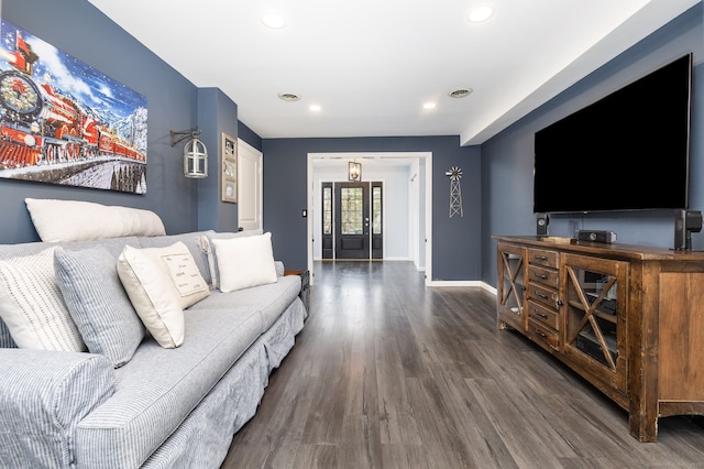 living room with baseboards, wood finished floors, and recessed lighting