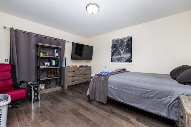 bedroom with dark wood-style flooring