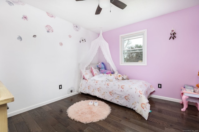 bedroom featuring baseboards, wood finished floors, and ceiling fan