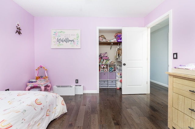 bedroom with wood finished floors and baseboards