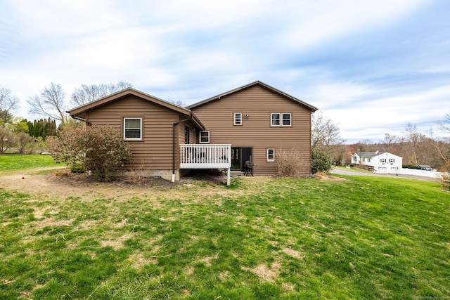 back of house with a yard and a deck