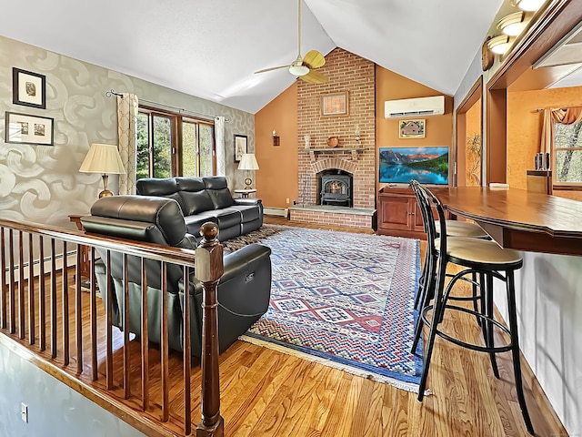 living room featuring wood finished floors, a healthy amount of sunlight, ceiling fan, baseboard heating, and an AC wall unit